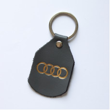 Брелок з логотипом авто "Audi" сірий з позолотою.